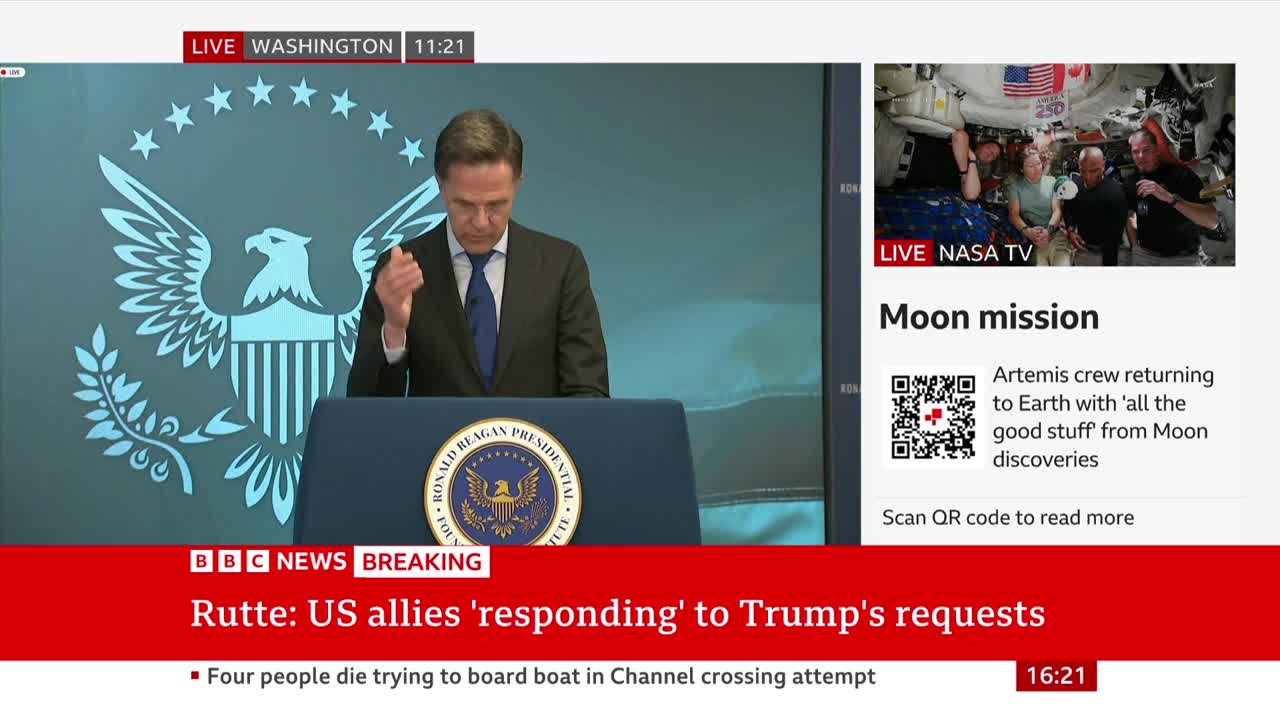 A man in a suit speaks at a podium, his hand raised. Beside him, a screen shows astronauts inside a spacecraft. The BBC News ticker at the bottom reports on allies responding to Trump's requests.