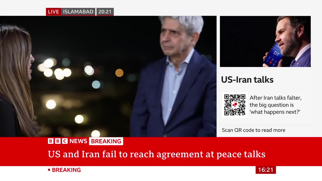A reporter stands in front of a man in a suit, with city lights twinkling behind them. The BBC News chyron states "US and Iran fail to reach agreement at peace talks."