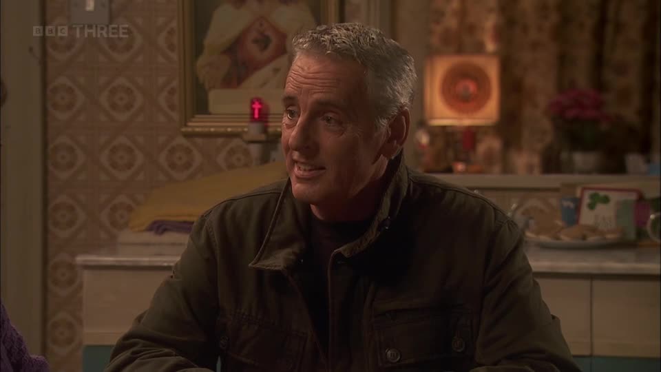 A man with grey hair speaks, his mouth open. The BBC Three logo is visible in the corner, suggesting this is a scene from a UK television show.