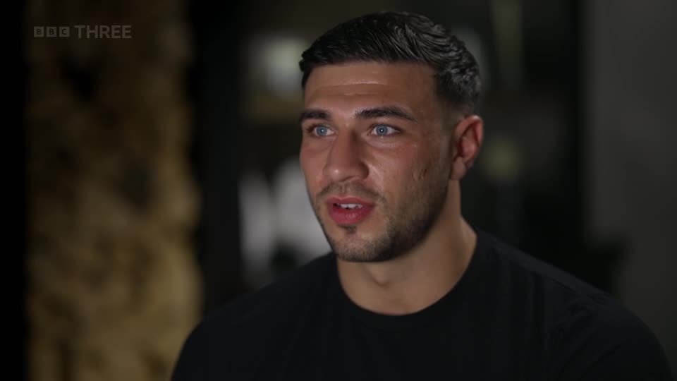 A young man with short, dark hair and striking blue eyes speaks directly to the camera. The BBC Three logo appears in the top left corner.