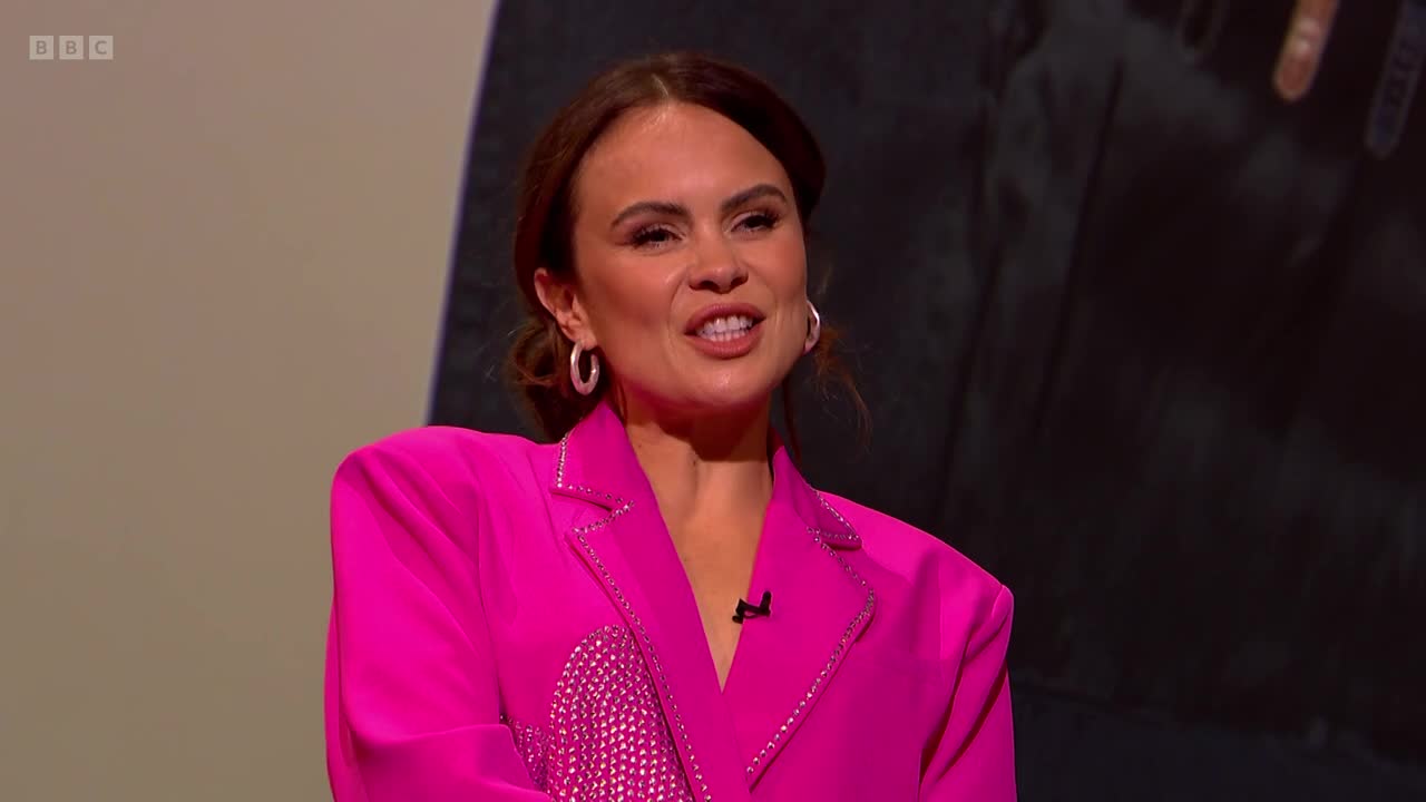 A woman in a bright pink blazer speaks animatedly, her mouth open mid-sentence. The BBC Two logo is visible in the top left corner.