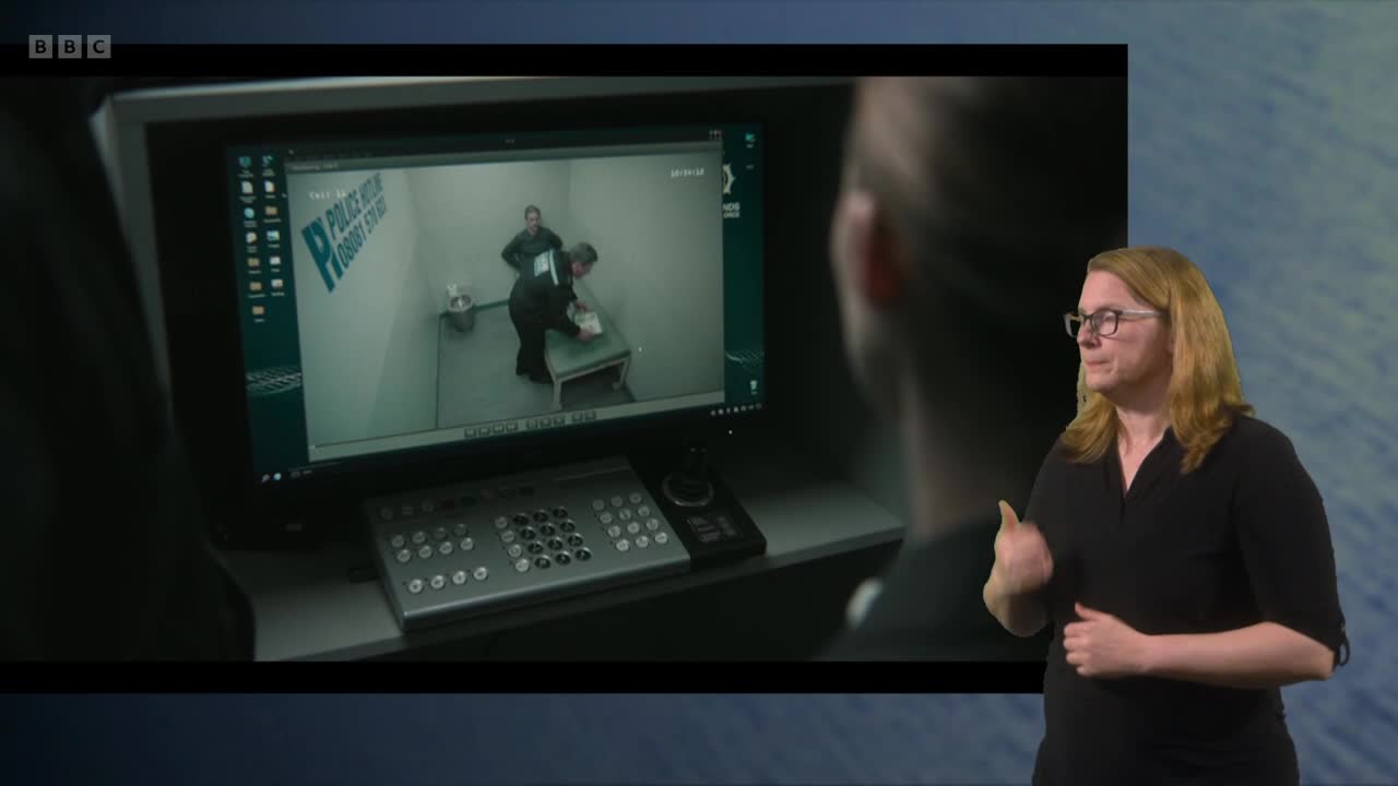 A woman is signing along to a program on BBC Two. On the screen, two officers are in a police interview room.