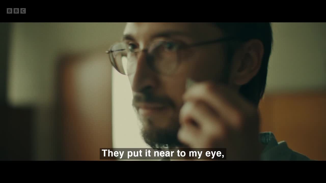 A man with glasses is holding something small up to his face. The BBC Two logo is visible in the corner.