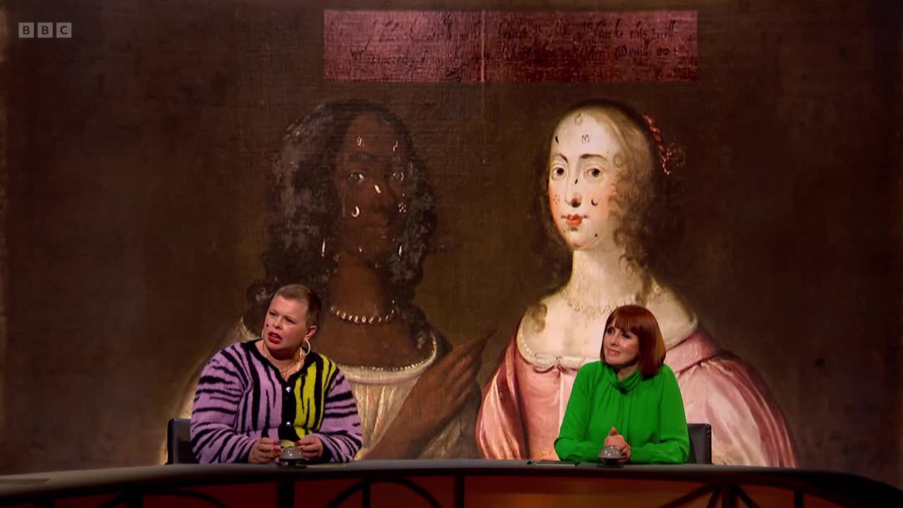 Two women sit at a table, looking towards a large, dark portrait of two women from centuries past. The BBC Two logo is visible in the corner of the screen.