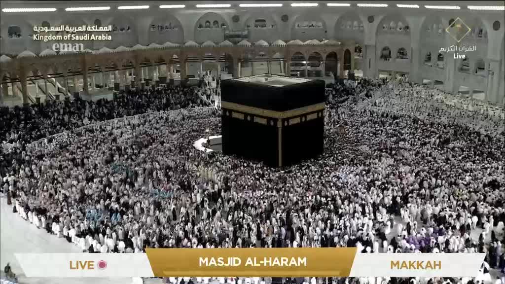 A sea of people in white garments swirls around a black cube, the Kaaba. I'm watching this live on Eman Channel from the United Kingdom.
