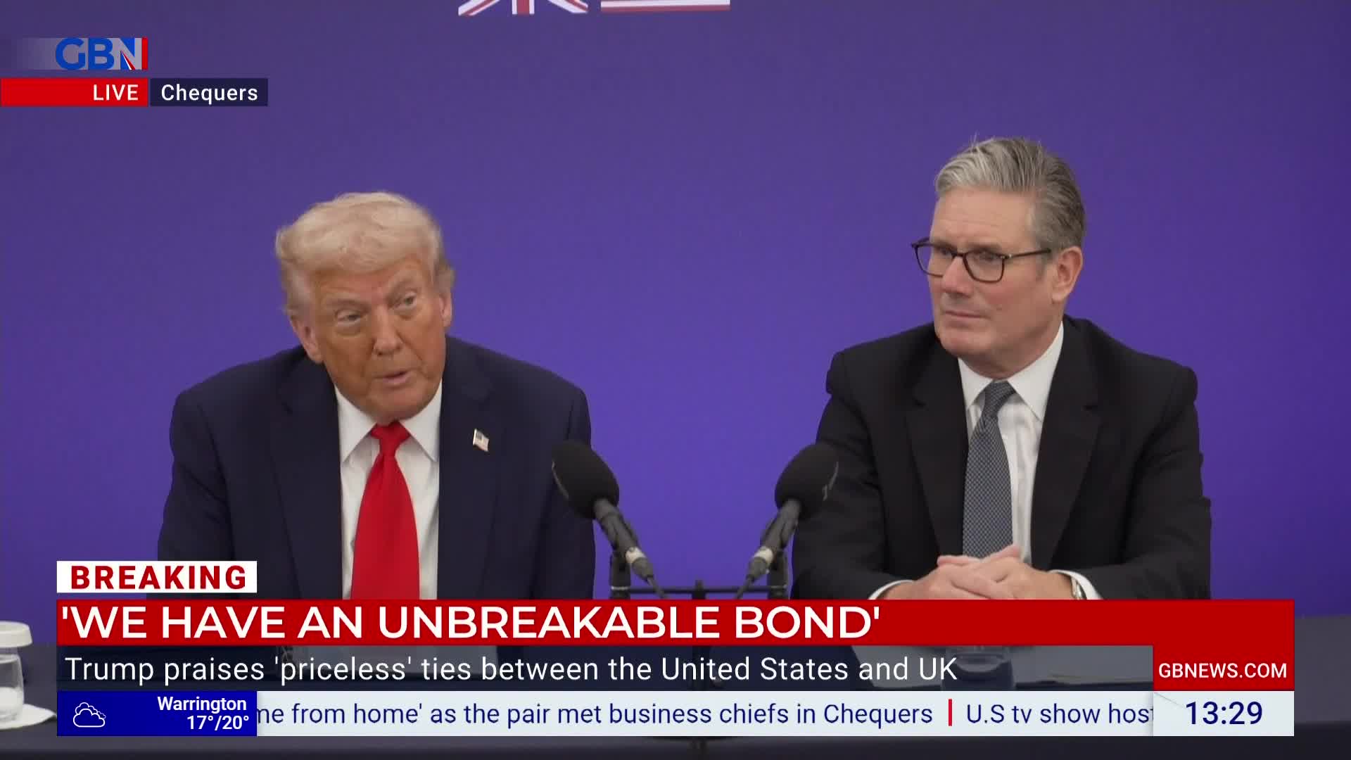 Donald Trump, in a navy suit and red tie, is speaking into a microphone on GB News, while Keir Starmer sits beside him, listening intently. The screen declares "We Have an Unbreakable Bond" between the United States and the UK.
