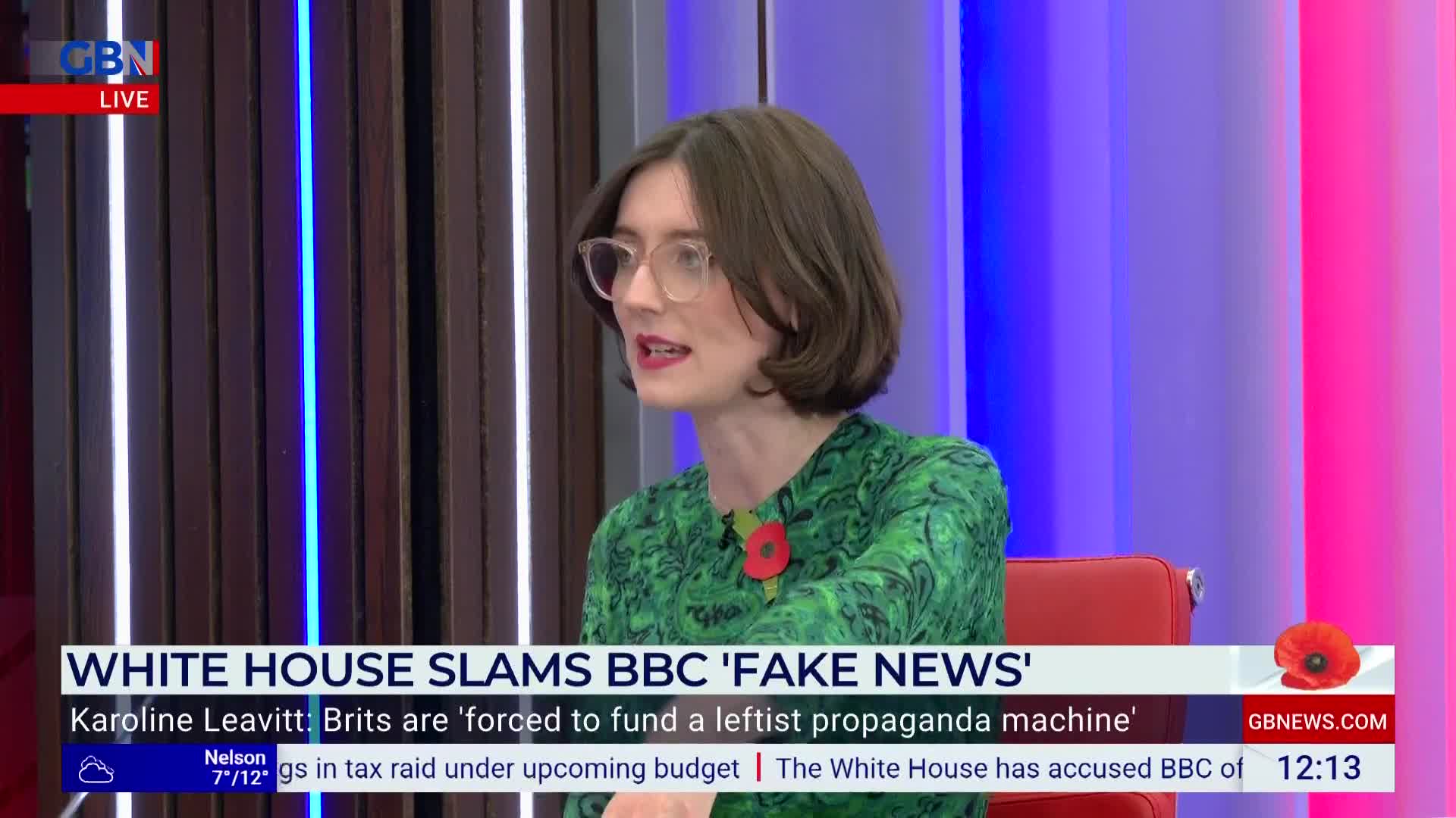 A woman in a green patterned dress, wearing glasses, speaks animatedly on a GB News set. The chyron beneath her highlights a story about the White House and the BBC.
A woman in a green patterned dress, wearing glasses, speaks animatedly on a GB News set. The chyron beneath her highlights a story about the White House and the BBC.