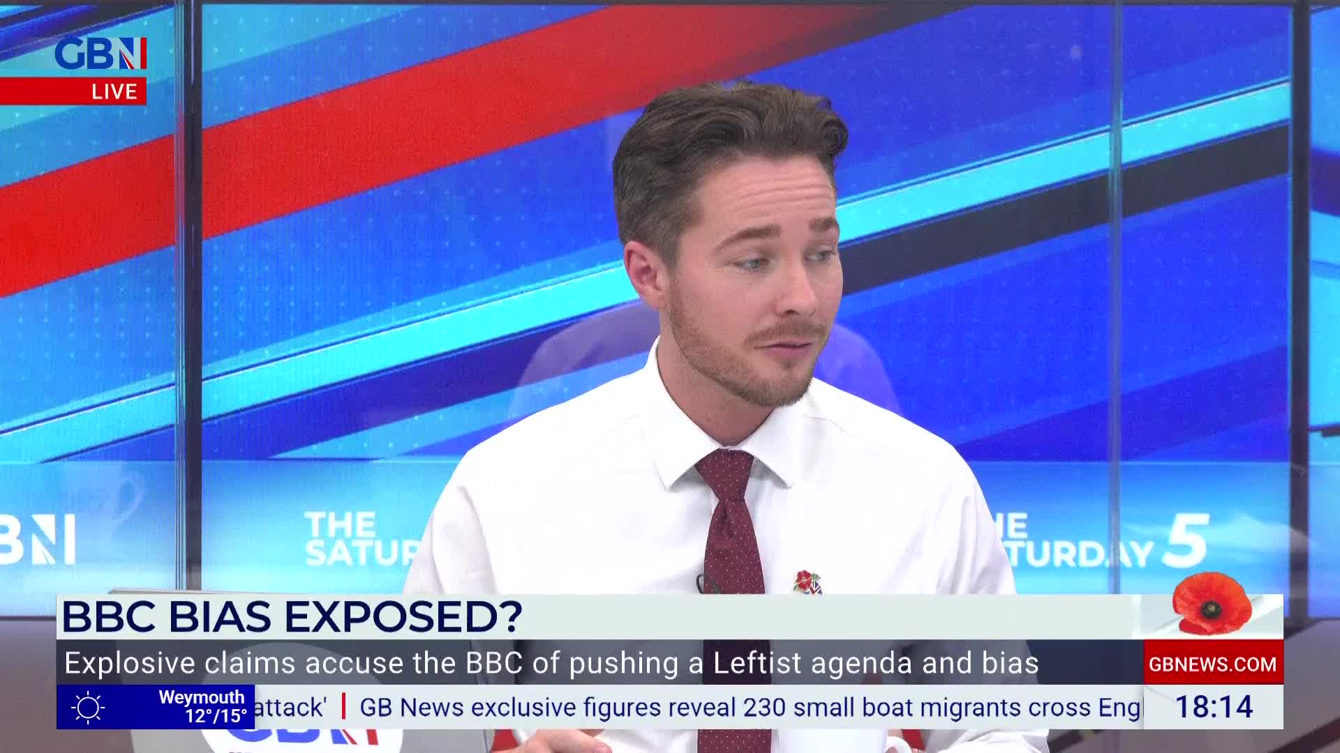 A man in a white shirt and tie is speaking on GB News, the backdrop a mix of red and blue. The lower third of the screen highlights a story about the BBC.
A man in a white shirt and tie is speaking on GB News, the backdrop a mix of red and blue. The lower third of the screen highlights a story about the BBC.