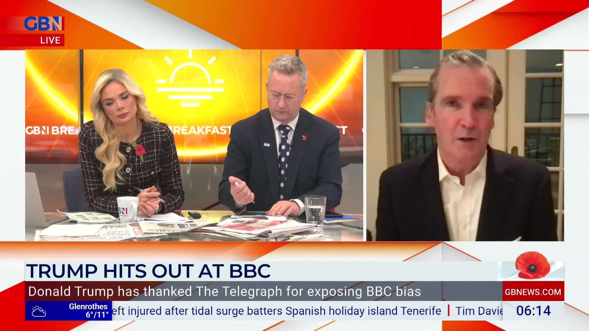 On GB News, a man in a suit is speaking from a remote location, framed by a window. Two other presenters sit at the desk, listening intently.
On GB News, a man in a suit is speaking from a remote location, framed by a window. Two other presenters sit at the desk, listening intently.