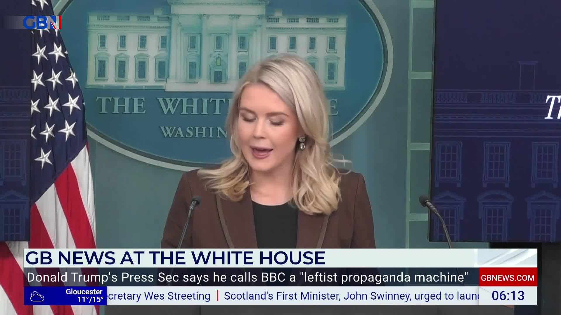 A woman with blonde hair, wearing a brown blazer, speaks into a microphone at a podium. The GB News logo is visible, and the backdrop shows the White House.
A woman with blonde hair, wearing a brown blazer, speaks into a microphone at a podium. The GB News logo is visible, and the backdrop shows the White House.