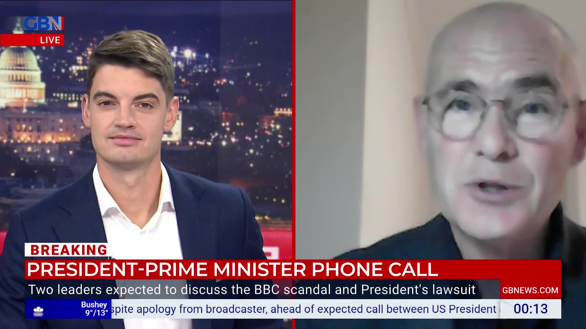 A man in a suit sits in a studio, looking at the camera. On the right, a man with glasses is speaking, presumably on a video call, as the GB News logo is visible.
