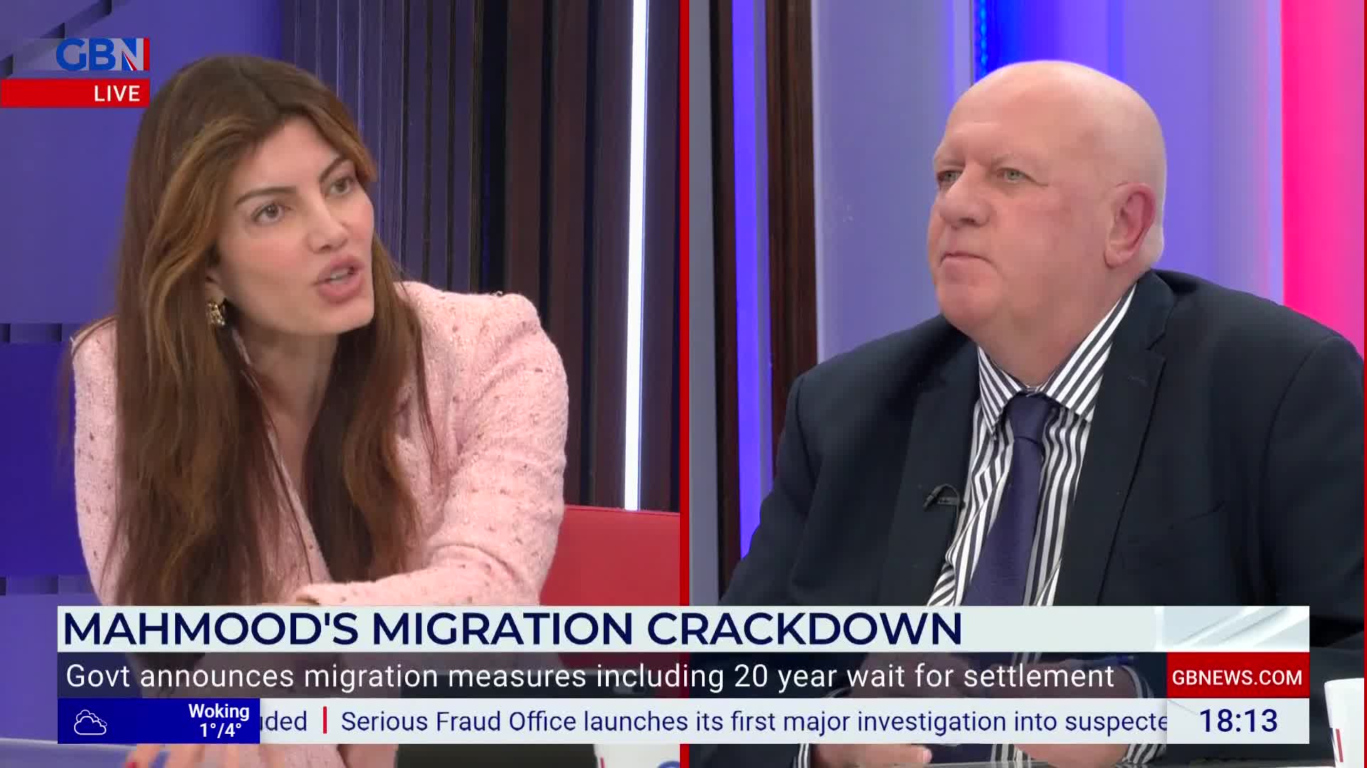 On GB News, a woman in a pink jacket speaks animatedly, while a man in a dark suit listens intently. The screen displays a headline about migration measures in the United Kingdom.
