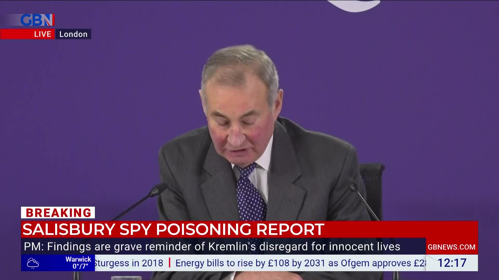 A man in a suit reads from a prepared statement, the "Salisbury Spy Poisoning Report" headline displayed on GB News. The screen's lower third gives additional context, including the time and location.
A man in a suit reads from a prepared statement, the "Salisbury Spy Poisoning Report" headline displayed on GB News. The screen's lower third gives additional context, including the time and location.