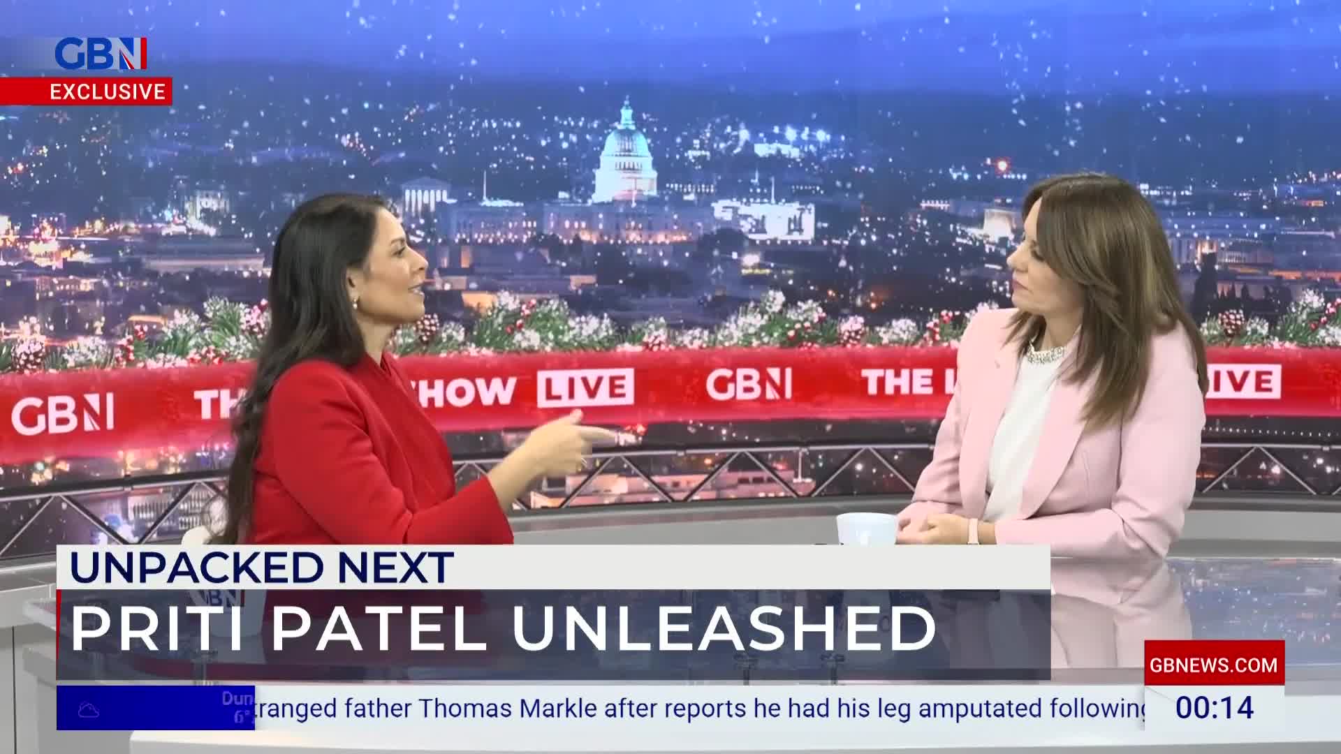 On a GB News set, two women are seated and engaged in conversation. The woman in red gestures with her right hand as she speaks, while the other in pink listens intently.
On a GB News set, two women are seated and engaged in conversation. The woman in red gestures with her right hand as she speaks, while the other in pink listens intently.