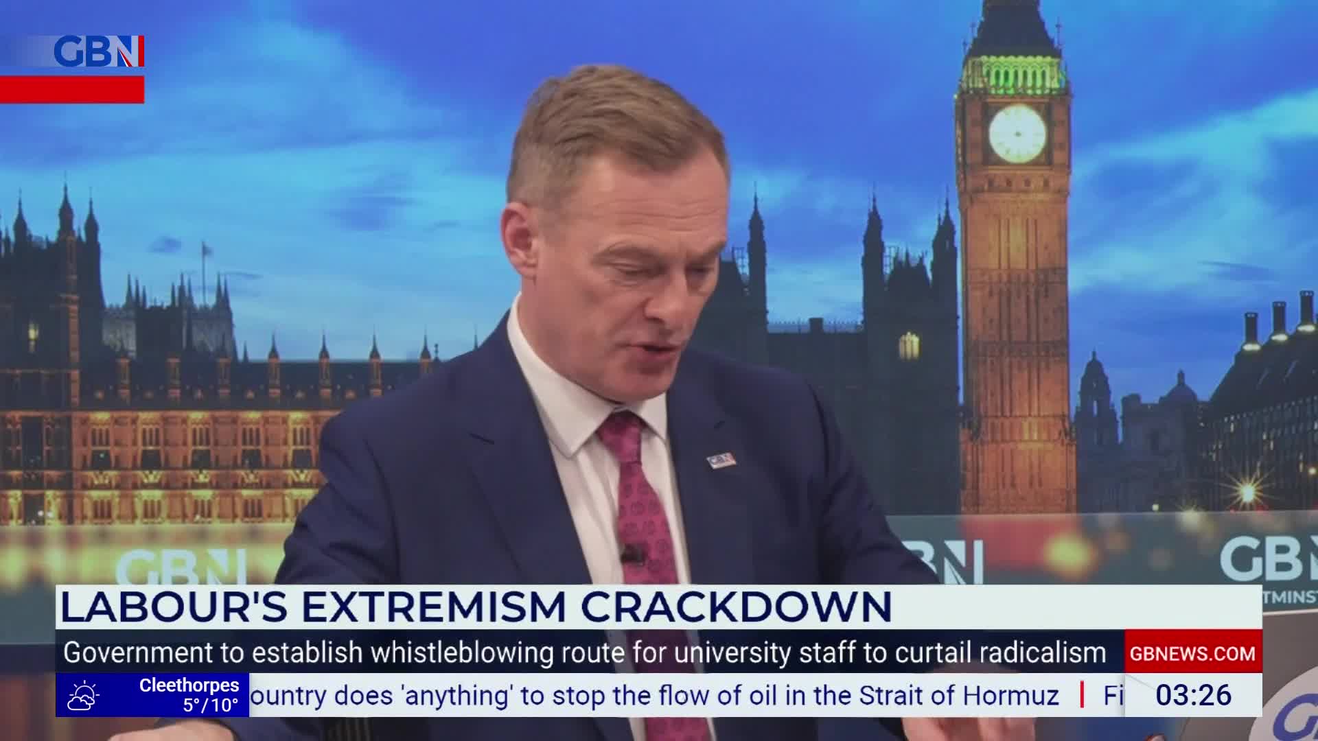 The presenter speaks with a backdrop of the Houses of Parliament, a headline about "Labour's Extremism Crackdown" displayed below him. A weather report for Cleethorpes and a news ticker about the Strait of Hormuz scroll across the bottom of the screen.