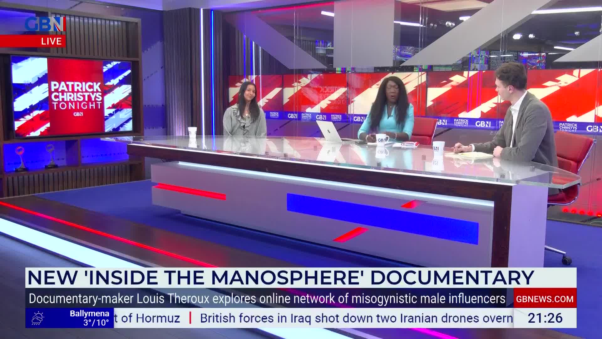 Two women sit at a desk in a studio, facing a man across from them. A screen behind them displays the GB News logo and the title "PATRICK CHRISTYS TONIGHT."