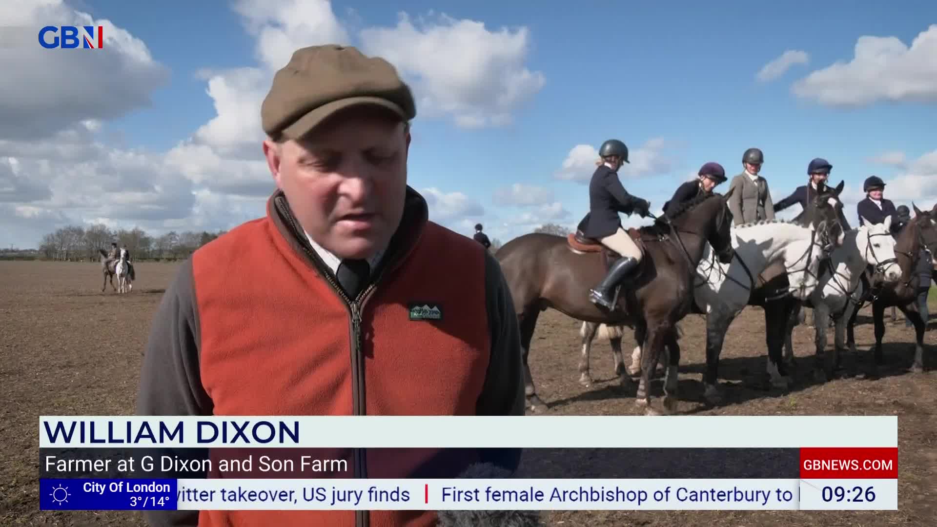 A group of riders on horseback waits in a field under a bright sky. One rider, dressed in a dark jacket and helmet, sits upright on a brown horse. A group of riders on horseback waits in a field under a bright sky. One rider, dressed in a dark jacket and helmet, sits upright on a brown horse.