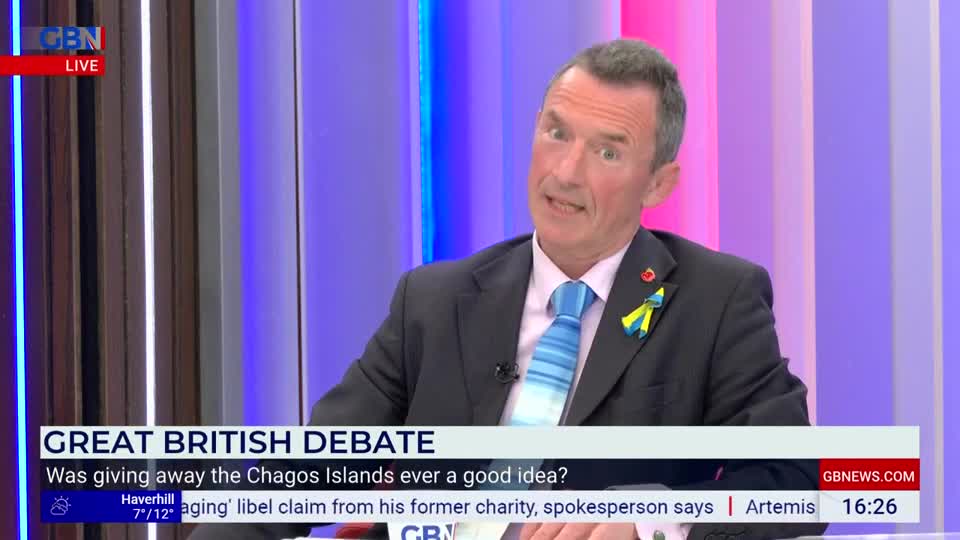 A man in a suit and tie, with a Ukrainian flag pin on his lapel, speaks animatedly. The "Great British Debate" title card is visible below him. A man in a suit and tie, with a Ukrainian flag pin on his lapel, speaks animatedly. The "Great British Debate" title card is visible below him.