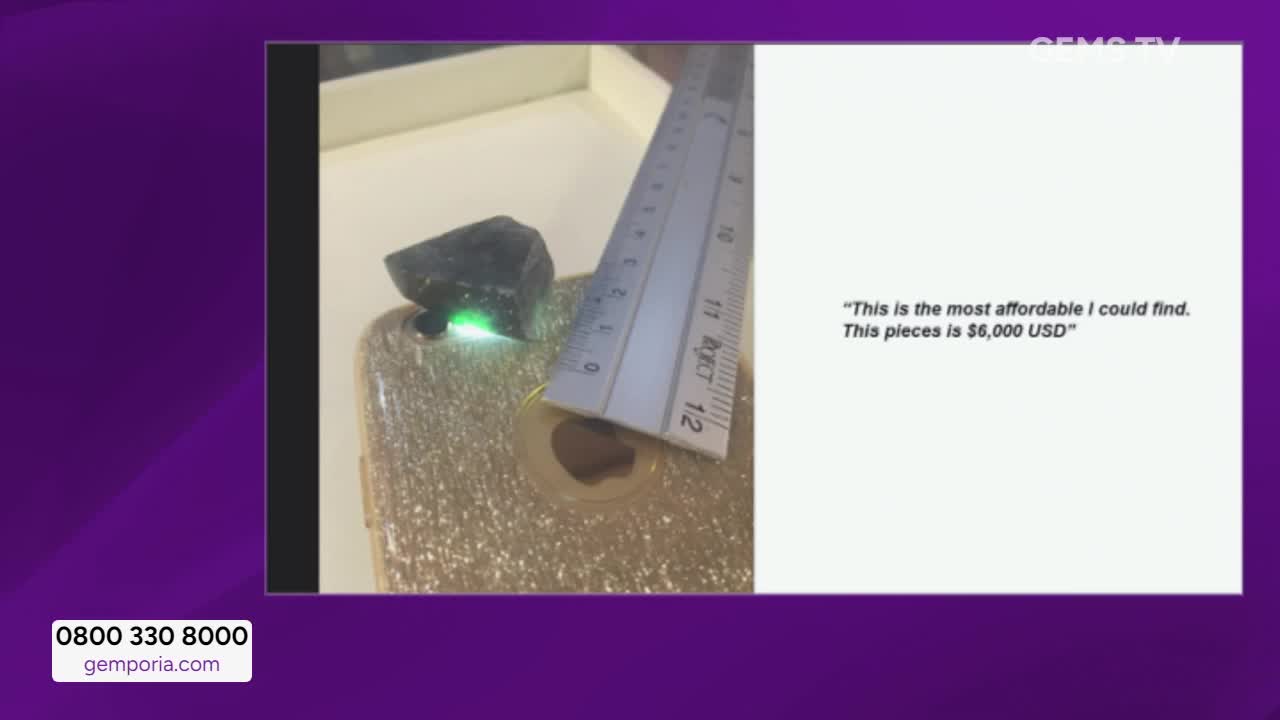 On Gems TV, a dark, rough gemstone sits atop a golden surface, a ruler positioned next to it. A quote on the screen states that this piece is $6,000 USD.
