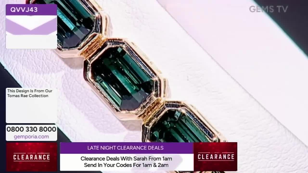 A gold bracelet with emerald-cut green gemstones sits on a white surface. The Gems TV logo is visible, and a "Clearance Deals" banner indicates a late-night sale is underway.
