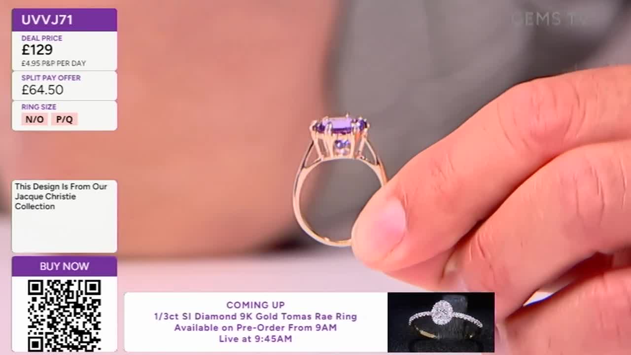 A hand holds up a gold ring with a large, purple gemstone, likely for a Gems TV presentation. The screen displays the price and ring size, alongside a QR code for buying.
