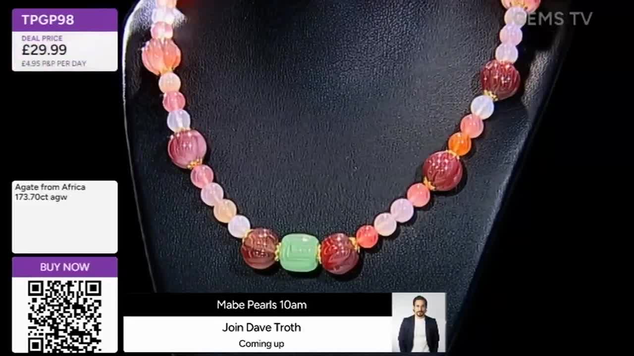 A gemstone necklace, comprised of various colored beads, is displayed on a black stand. The Gems TV logo is visible, along with a deal price of £29.99 for the agate necklace.
