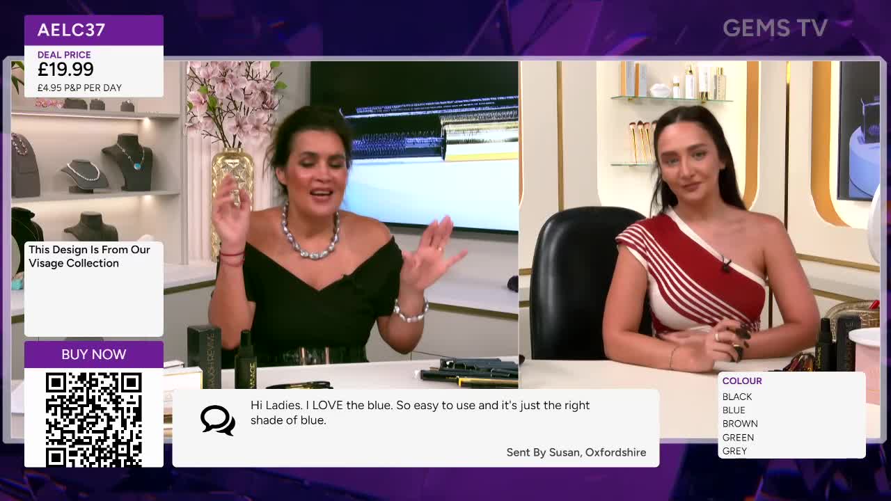 The woman in the black dress gestures with both hands, speaking enthusiastically. Across the set, another woman sits, listening, while a list of colors is displayed on the screen.
