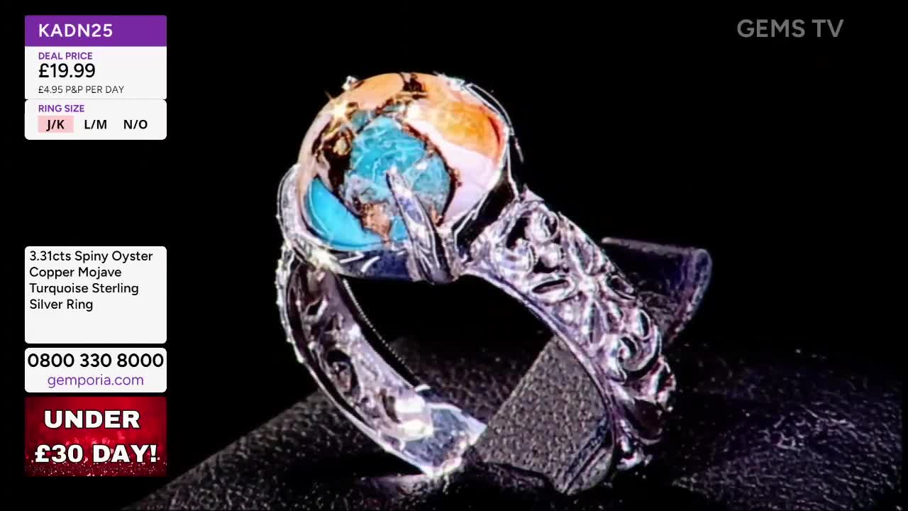 A detailed silver ring with a colorful gemstone is displayed against a black backdrop. The ring is being presented on Gems TV, with a price and size information visible on the screen.
