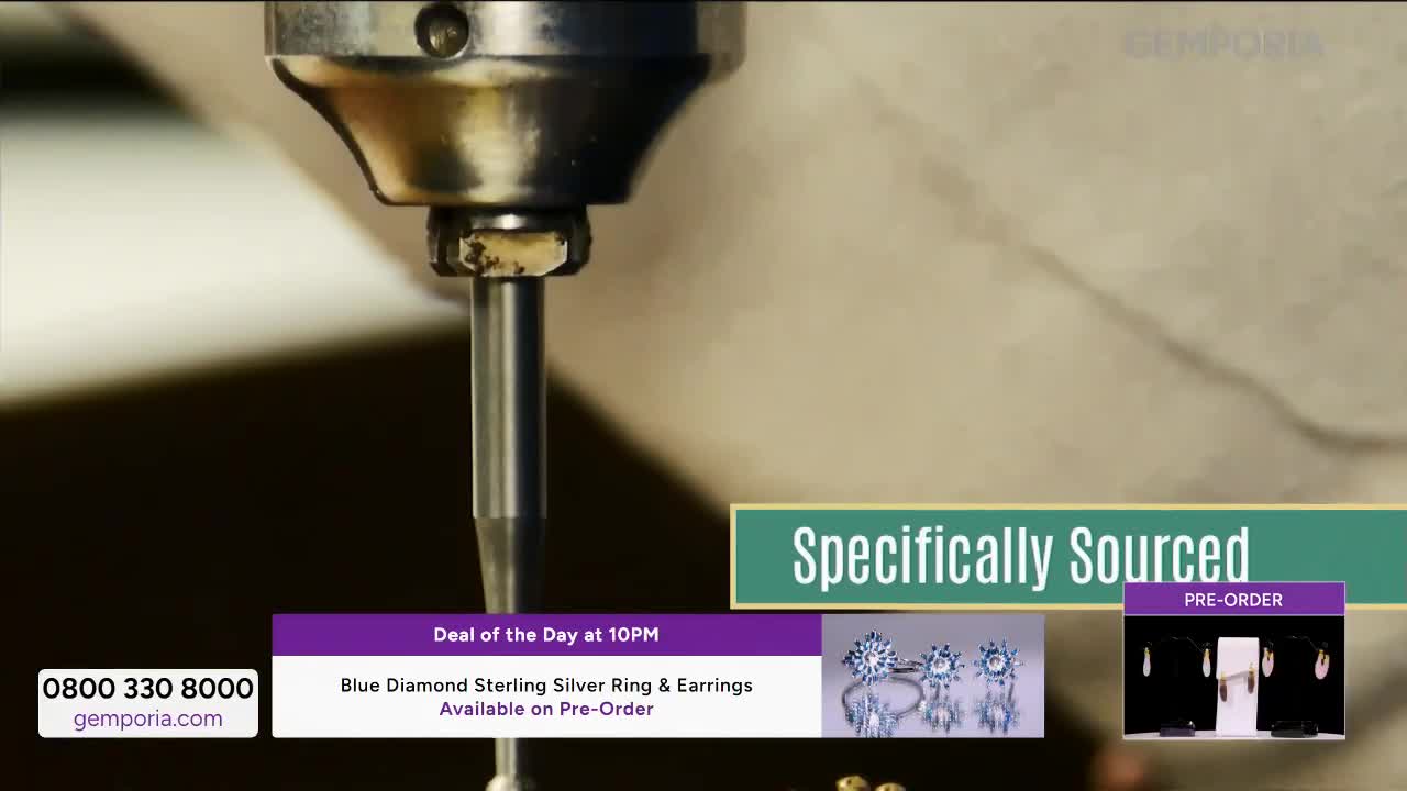 A drill bit, part of a larger machine, is poised over something metallic. A graphic overlay announces "Specifically Sourced" and a "Deal of the Day at 10PM" featuring a blue diamond sterling silver ring and earrings available for pre-order.