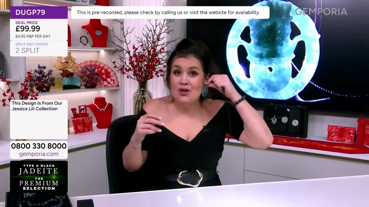 She's showing off a pair of teal earrings from the Jessica Lili collection. A large, glowing blue pendant hangs on the screen behind her.