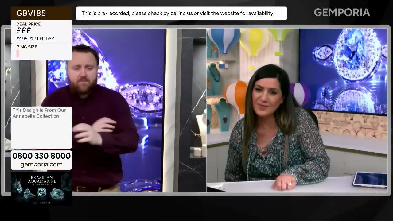 A man in a maroon shirt gestures with his hands. A woman with dark hair smiles and speaks.