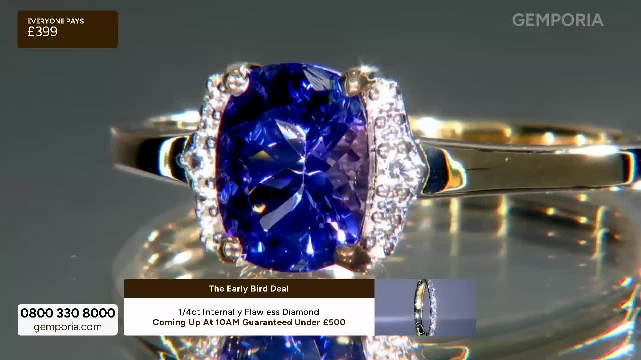 A large, deep blue gemstone sits at the centre of a gold ring, surrounded by smaller, sparkling stones. This ring, featured on Gems TV, is being presented as an early bird deal for £399.