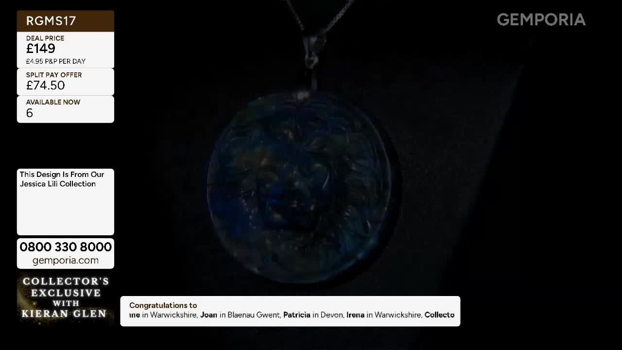 The large, circular pendant, showcasing swirling blues and golds, hangs suspended. A silver chain connects it to an unseen point above. The large, circular pendant, showcasing swirling blues and golds, hangs suspended. A silver chain connects it to an unseen point above.