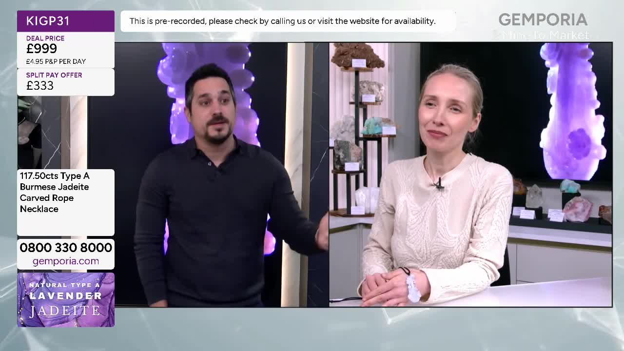 A man gestures enthusiastically as he talks, while a woman smiles beside him. They are presenting a necklace on Gems TV.