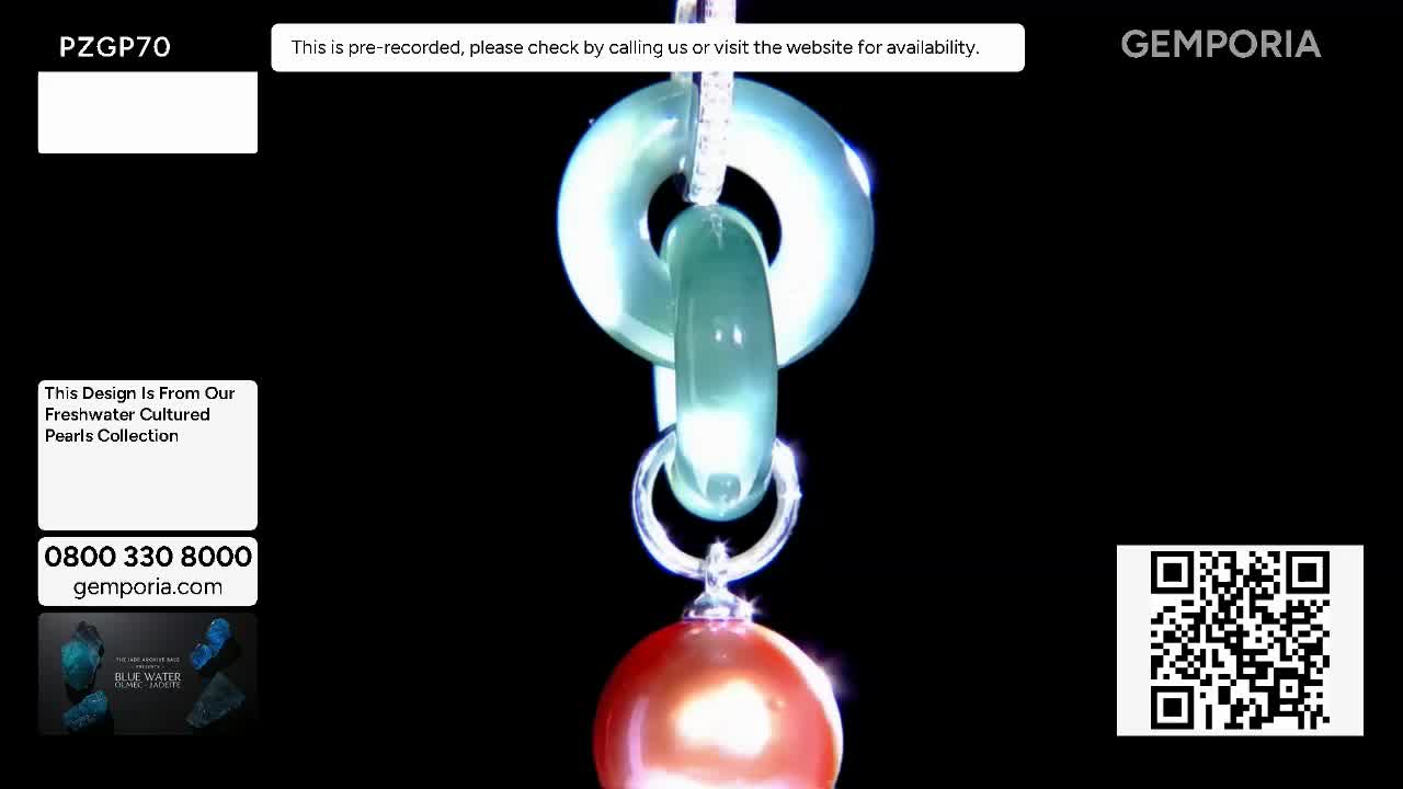 A large, pale green jade pendant swings gently, its smooth surface catching the light. Below it, a single, lustrous coral-coloured pearl dangles from a delicate silver ring. A large, pale green jade pendant swings gently, its smooth surface catching the light. Below it, a single, lustrous coral-coloured pearl dangles from a delicate silver ring.
