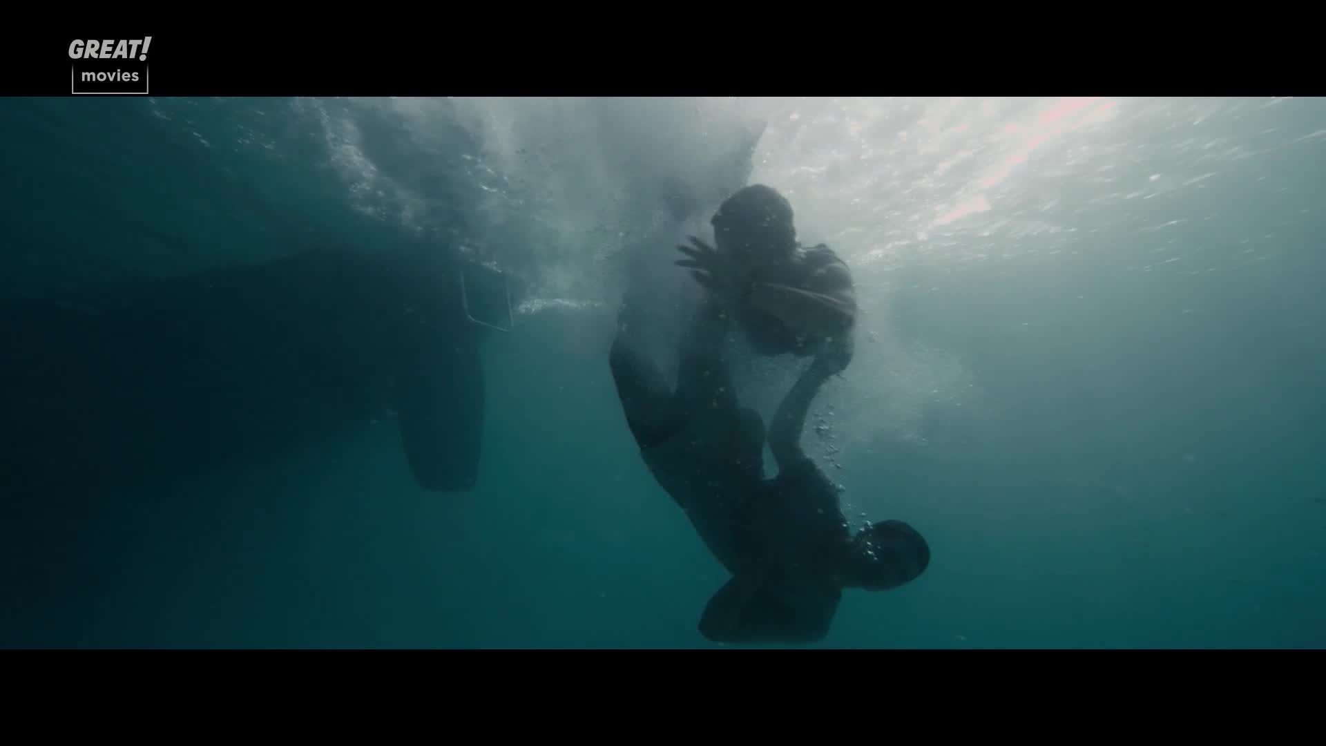 The figures are submerged, struggling in the water beneath a boat's hull. One is reaching out, and the other is sinking downwards.
