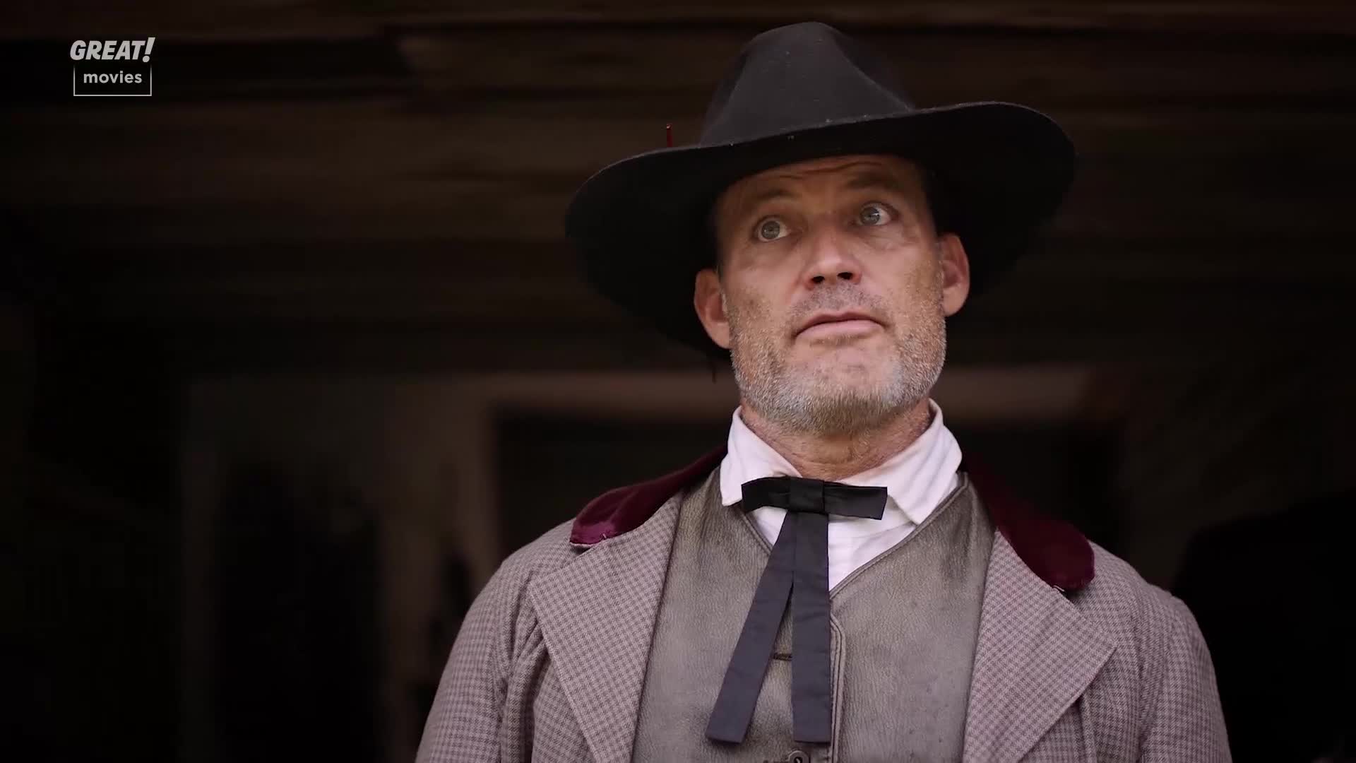 The man in the hat stares up, eyes wide with surprise. His waistcoat and cravat are a stark contrast to the dirt on his face.
