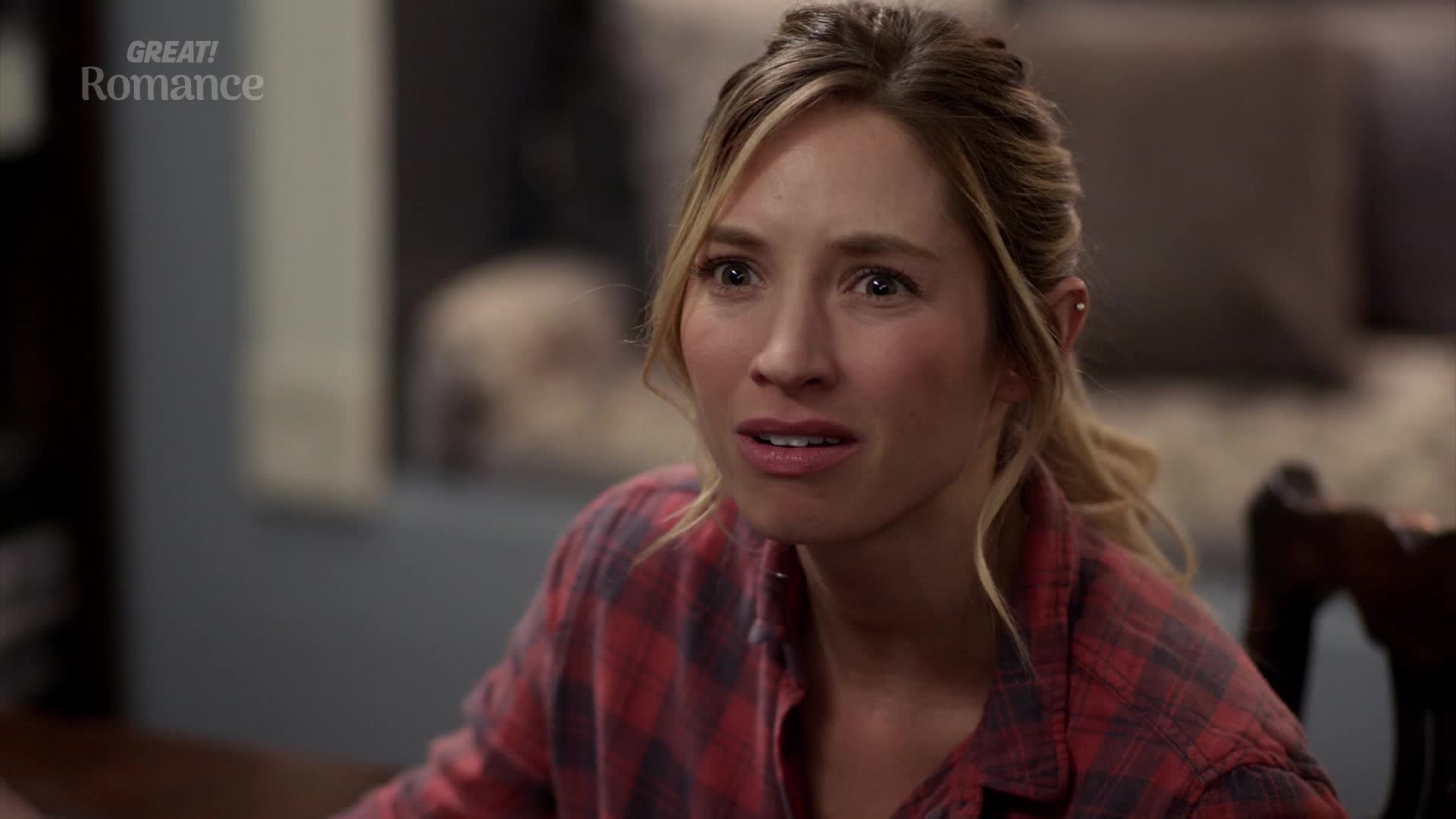 A young woman with blonde hair pulled back in a ponytail looks off to the side, her expression a mixture of surprise and concern. She wears a red and black plaid shirt, her gaze fixed on something outside the frame. A young woman with blonde hair pulled back in a ponytail looks off to the side, her expression a mixture of surprise and concern. She wears a red and black plaid shirt, her gaze fixed on something outside the frame.