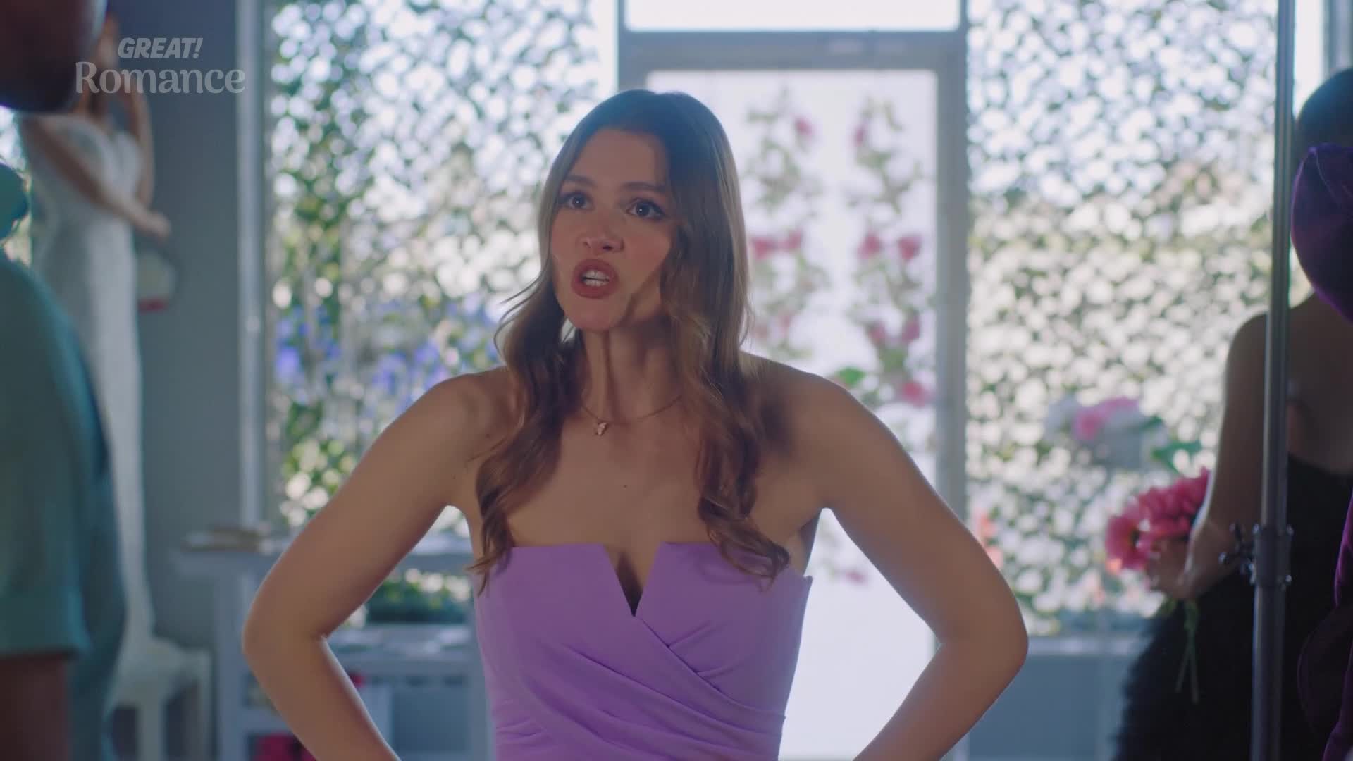 She's in a bridal shop, her face contorted in frustration as she gestures emphatically. The air is thick with unspoken tension, a stark contrast to the romantic setting.