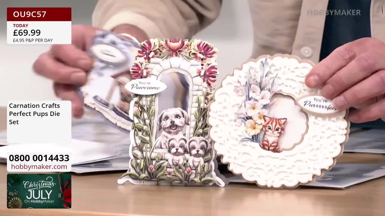 A person holds up two decorative die-cut paper crafts, one with a puppy theme and the other with a kitten. The Hobby Maker logo is visible in the background, suggesting it is a craft demonstration.
