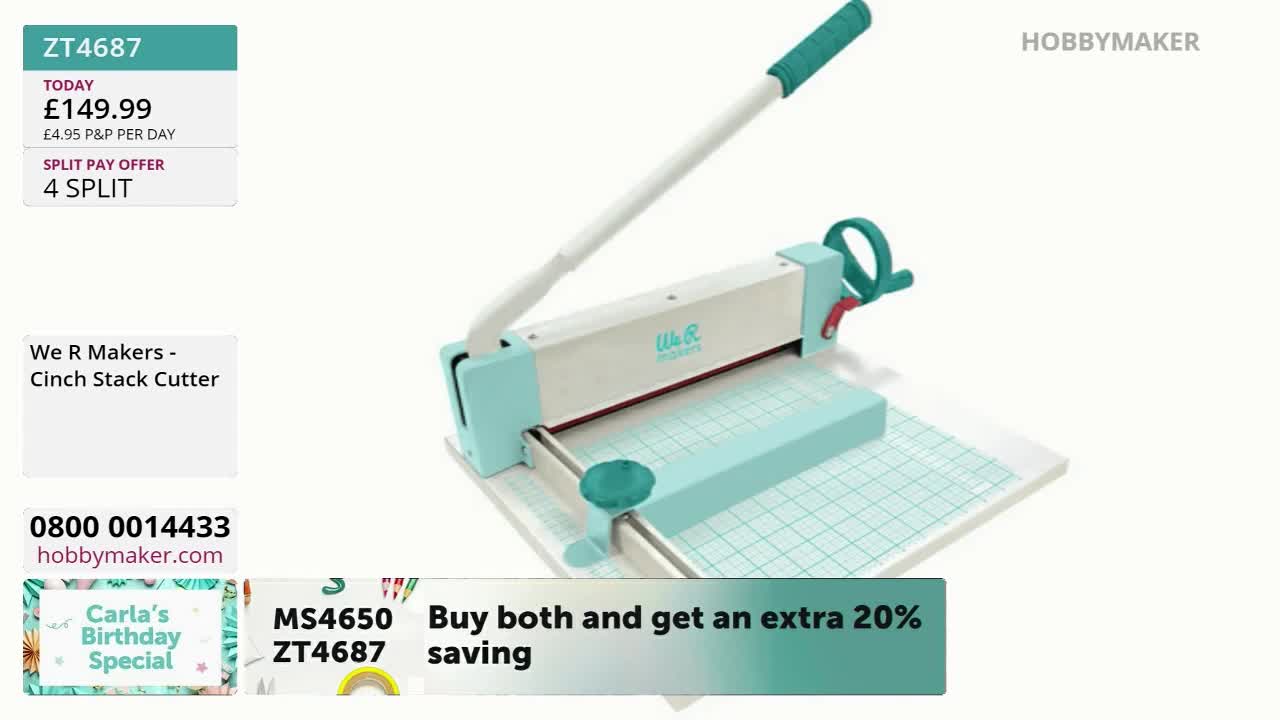 A mint-green and white paper cutter sits on a grid, ready for use. The long handle is raised, and the price of the item is displayed on screen by Hobby Maker.
