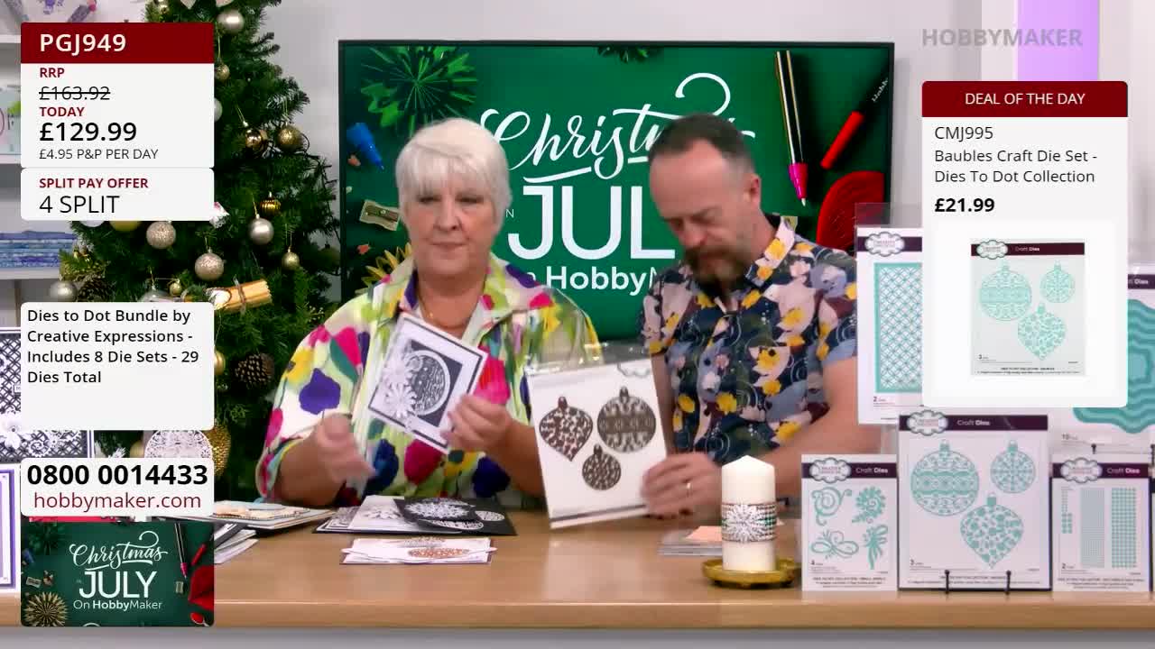 A woman in a colorful shirt holds up a finished craft, while a man next to her presents a set of bauble dies. Both are on a set for Hobby Maker, with Christmas-themed products.
