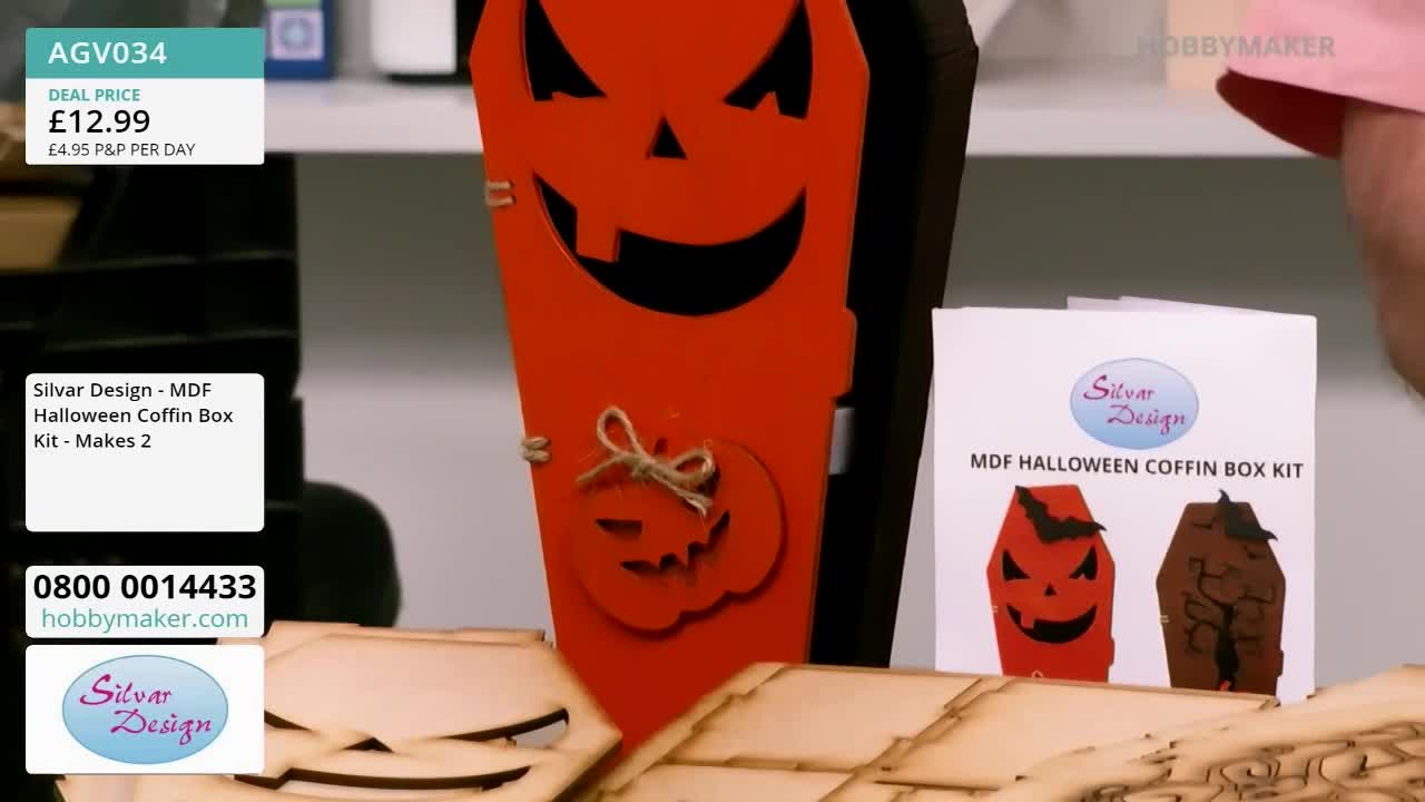 A bright orange coffin, decorated with a jack-o'-lantern face, stands upright. Beside it, a kit from Hobby Maker promises to make two more.
