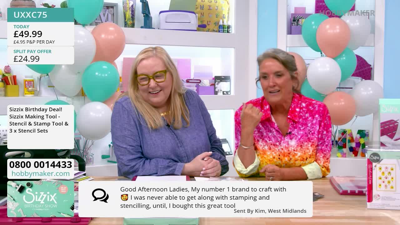 Two women are seated at a table, smiling and gesturing as they speak on a television show. Behind them, balloons in pastel colors float, and a Hobby Maker logo is visible on the screen.
