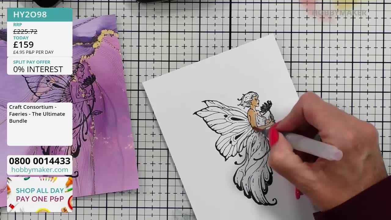 A hand with red nail polish carefully colors a black and white fairy illustration with a brush. Beside it, a finished version of the design, part of a Hobby Maker bundle, is displayed.

