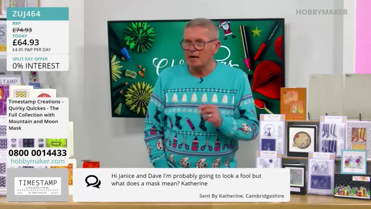 A man in a patterned sweater gestures as he speaks, presumably on a Hobby Maker broadcast. Behind him, various craft projects and a chalkboard with the word "Christmas" are visible.
