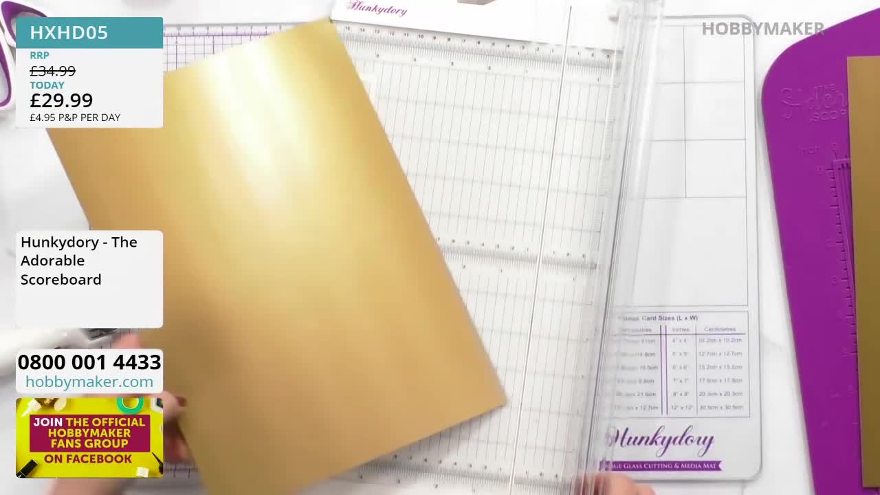 A large sheet of gold card is being positioned on a cutting board. The Hobby Maker logo is visible in the corner.
