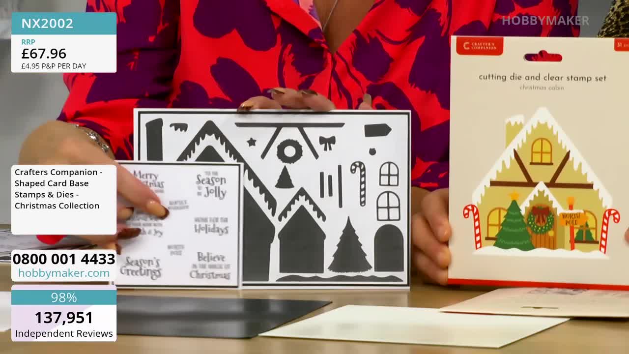 A woman in a patterned red top holds up a set of Christmas-themed crafting dies and stamps from Hobby Maker. The packaging shows a finished gingerbread house card, while the woman points to the die-cut shapes.
