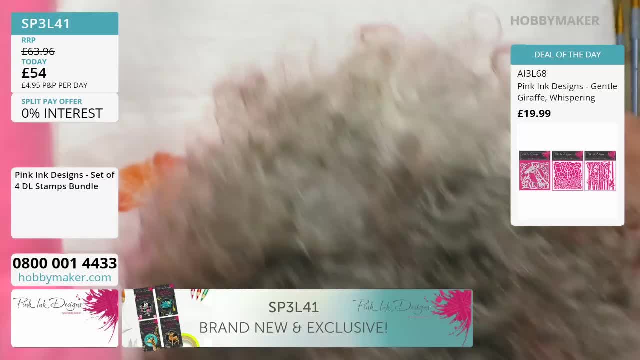 A fuzzy, light-coloured object is moving rapidly across the frame. A white box with text about a "Pink Ink Designs - Set of 4 DL Stamps Bundle" is visible on the left.