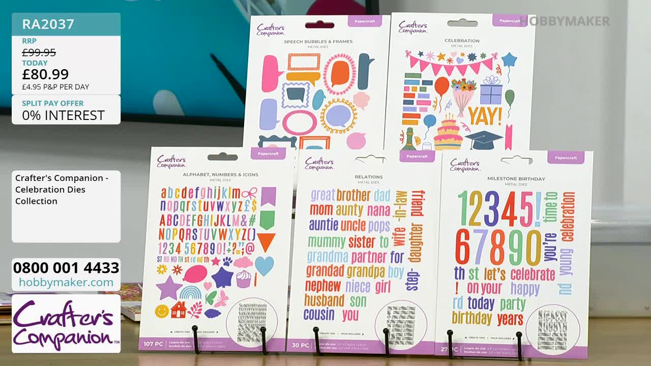 A display of Crafter's Companion metal dies for papercraft sits on a table. The packaging features colourful designs for celebrations, alphabets, and family relations.